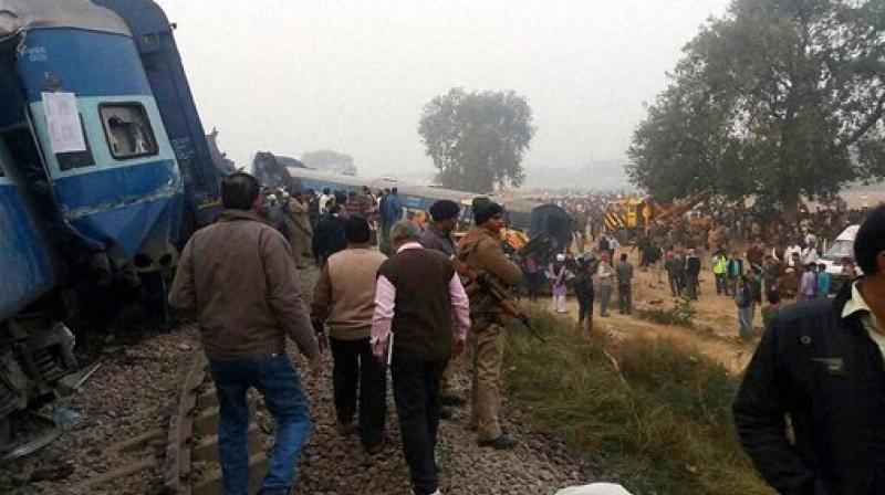 Police officers on the spot where 14 coaches of the Indore-Patna express derailed, killing around 90 people and injuring 150, in Kanpur Dehat on Sunday. (Photo: PTI)