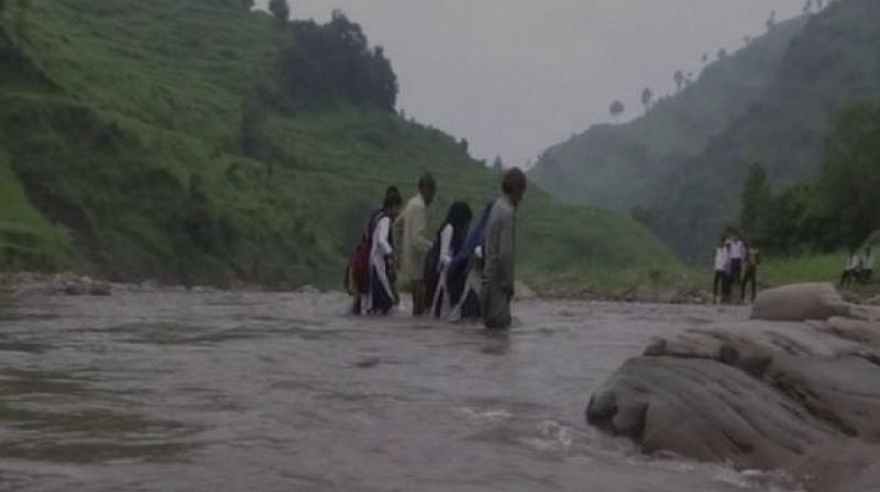 The locals have also been demanding the government to build a bridge so that children from underprivileged backgrounds, for whom, government schools are the last option, can attend schools on a regular basis. (Photo: ANI)