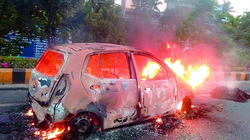 A car goes up in flames on Eluru Road at Nidamanuru near Vijayawada on Wednesday.  (DC)