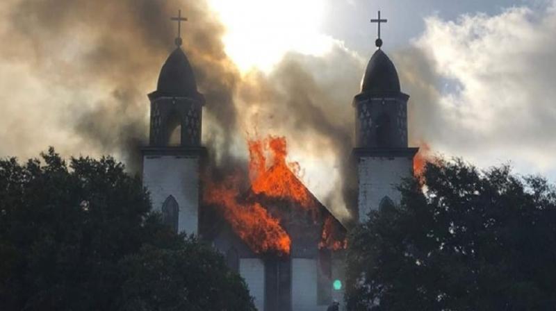 Photos posted on the Austin Catholic diocesan Facebook page show the Church of the Visitation in Westphalia fully involved in flames Monday morning, being reduced to nothing more than ashes. (Photo: Facebook)