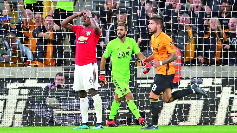 Manchester Uniteds Paul Pogba (right) reacts after his penalty was saved by Wolverhampton goalkeeper Rui Patricio in the English Premier League match at the Molineux Stadium in Wolverhampton on Monday. (Photo: AP)