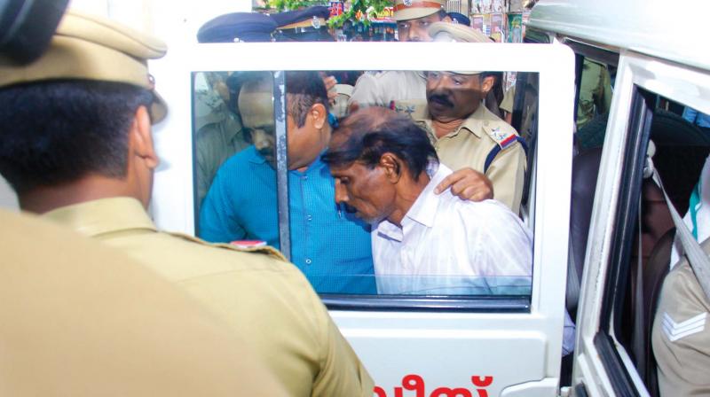 Police bring Victor Daniel to court in Kollam on Monday.