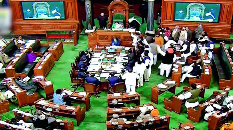 Opposition members protest inside the Lok Sabha in New Delhi on Wednesday during the ongoing Winter Session of Parliament (Photo: AP)