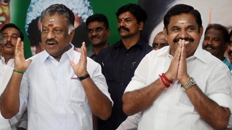 Tamil Nadu Chief Minister K Palaniswami (R) and O Panneerselvam exchange greetings with supporters following merger of their factions in Chennai on Monday. (Photo: PTI)
