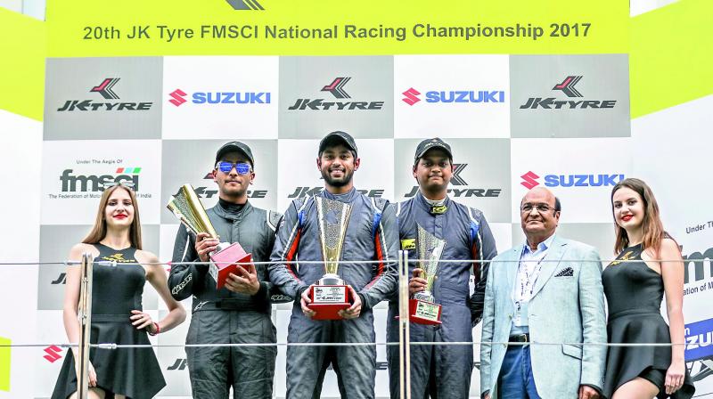 Nayan Chatterjee (from left), Anindith Reddy of Hyderabad and Vishnu Prasad pose with the trophies secured at the 20th JK Tyre FMSCI National Championship at the BIC.