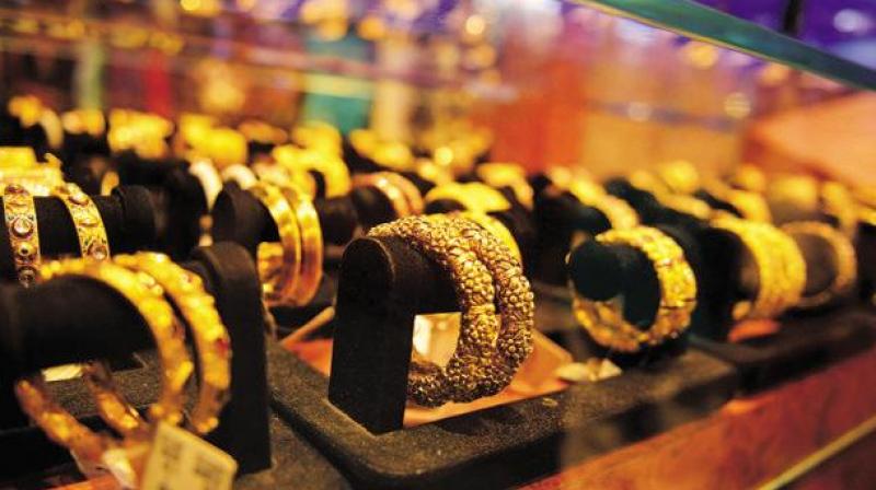 Standard gold of 99.5 per cent purity slid Rs 265 to conclude at Rs 28,495 per 10 grams as against Thursdays closing level of Rs 28,760.