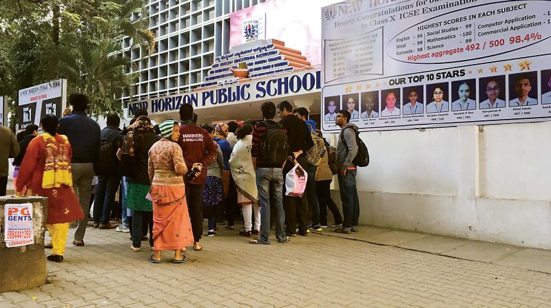 Parents queue up outside New Horizon Public School in Indiranagar on Saturday