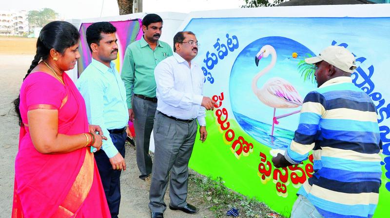 Joint Collector A. Md. Imtiaz is seen suggesting some modifications to wall painting for upcoming Flamingo Festival at Sullurpeta during a visit on Thursday. (Photo: DC)