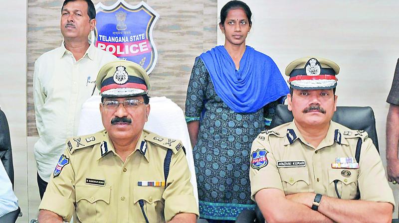 Mr M. Mahender Reddy, DGP, with Jilugu Narsimha Reddy alias Jampanna and his wife Anitha alias Rajitha  after their surrendered at a press conference on Monday. (Photo: DC)