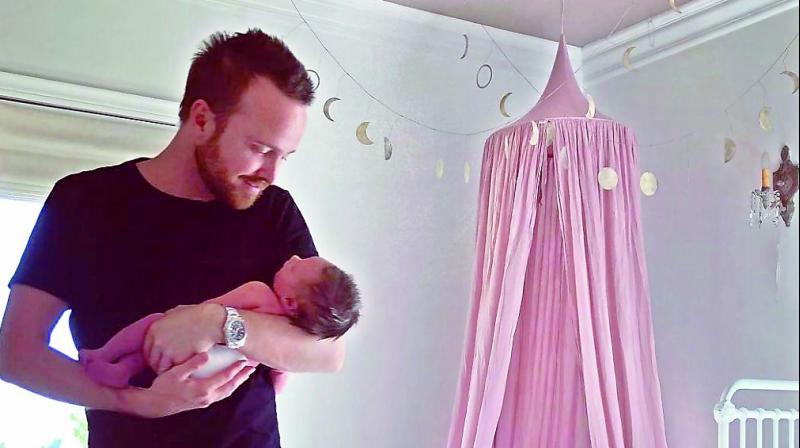 Aaron Paul with his baby daughter Story Annabelle