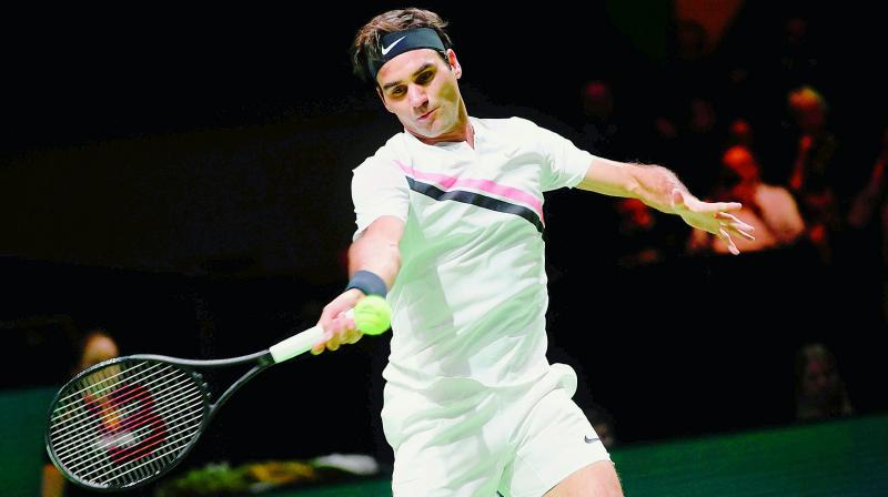 Roger Federer of Switzerland plays a forehand return to Robin Haase of The Netherlands during their quarterfinal singles match for the ABN AMRO World Tennis Tournament in Rotterdam on Friday. (Photo:AFP)