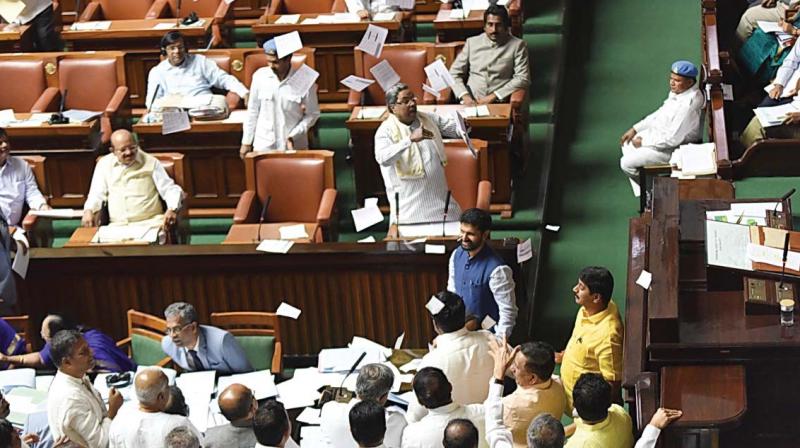 Ruling Congress members led by Chief Minister Siddaramaiah and Opposition members argue over an issue during the Assembly session in Bengaluru on Friday.  (Photo:DC)