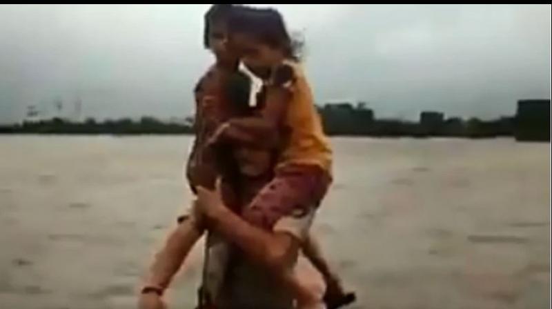 Watch: Gujarat cop carries children on shoulders for 1.5 km in floodwater