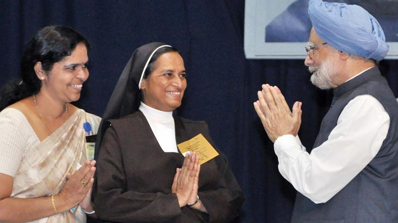 Former Prime Minister Manmohan Singh greets Sr Christabel, manager of St. Teresas College and principal Dr Sajimol Augustine during the national seminar at the college in Kochi on Saturday. (Photo: DC)