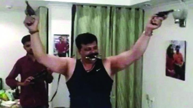 MLA from Khanpur in Uttarakhand, Pranav Singh Champion, is seen wielding guns in the video grab.