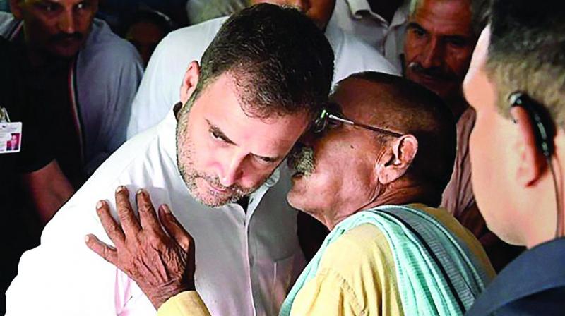 Congress leader Rahul Gandhi listens to a party worker during his visit to Amethi on Wednesday.   (PTI)