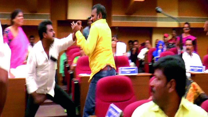 YSRC Corporator Devarakonda Ashok in scuffle with Telugu Desam Corporatior Prasanth at the Corporation Council meeting in Nellore on Friday. (Photo: DC)