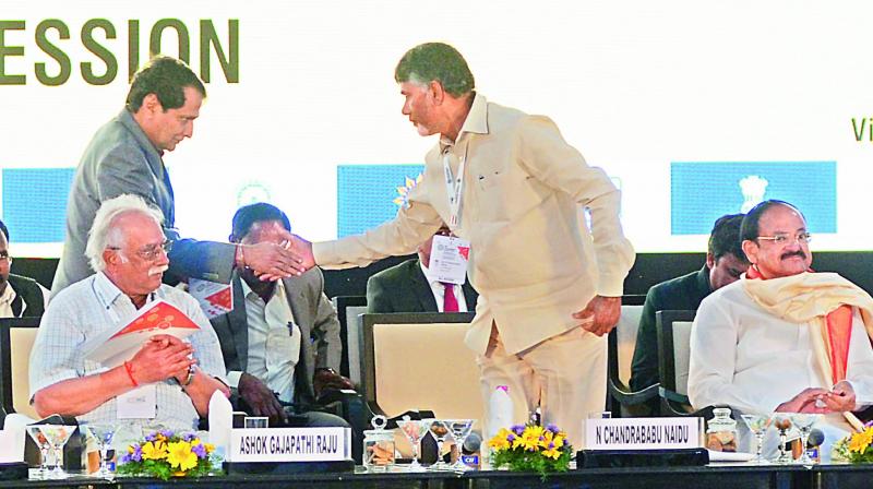 Chief Minister N.Chandrababu Naidu shakes hand with the Union Commerce minister Suresh Prabhu as the Vice-President M. Venkaiah Naidu and Civil Aviation minister P. Ashok Gajapathi Raju look on at the inaugural session of the 3rd CII Partnership Summit at APIIC Grounds in Visakhapatnam on Saturday. (Photo: DC)