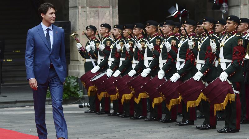 Canadian Prime Minister Justin Trudeau walks past the honour guard during a welcoming ceremony at the Palacio Nacional in Mexico City. (Photo: AP)
