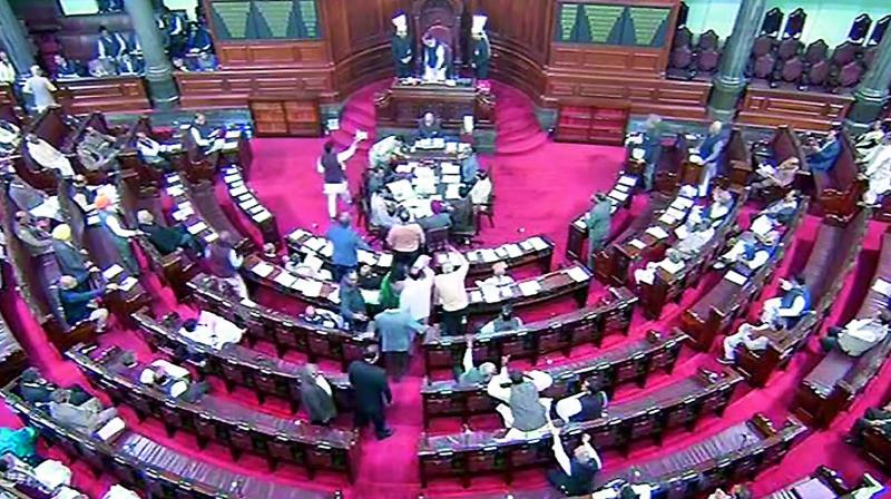 Rajya Sabha members protest in the Well during the Session on Tuesday. (Photo: PTI)