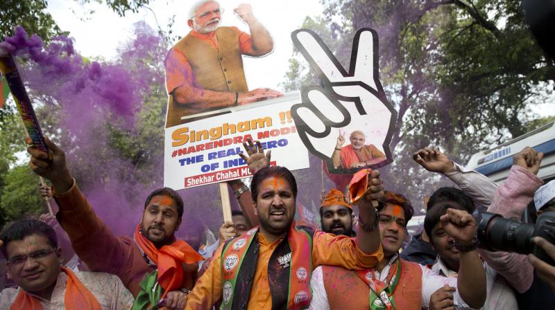 Bharatiya Janata Party (BJP) supporters celebrate as their party leads in Assembly elections in Uttarakhand and Uttar Pradesh. (Photo: AP)