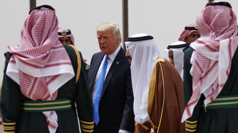 US President Donald Trump, center left, walks with Saudi King Salman, center right, during a welcome ceremony at the Royal Terminal of King Khalid International Airport. (Photo: AP)