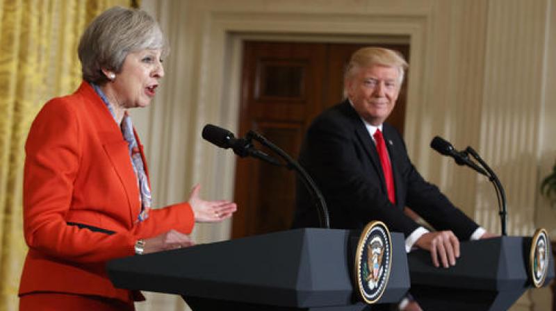 President Donald Trump listens as British Prime Minister Theresa May speaks during a news conference in the East Room of the White House in Washington. (Photo: AP)