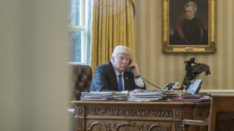 President Donald Trump speaks on the phone with Russian President Vladimir Putin from Oval Office. (Photo: AP)