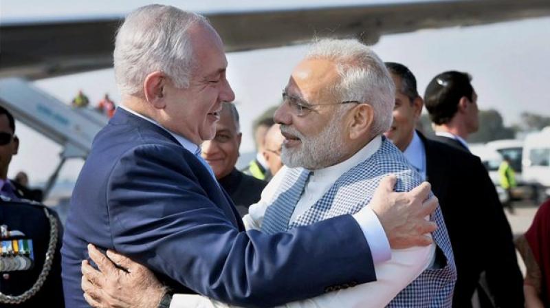 Prime Minister Narendra Modi welcomes Israeli Prime Minister Benjamin Netanyahu on his arrival at Air Force Station, Palam, in New Delhi on Sunday. (Photo: PTI)