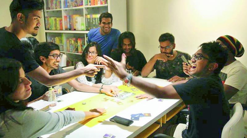 A group of youngsters enjoy a board game at Indias largest board game cafe. (Photo: DC)