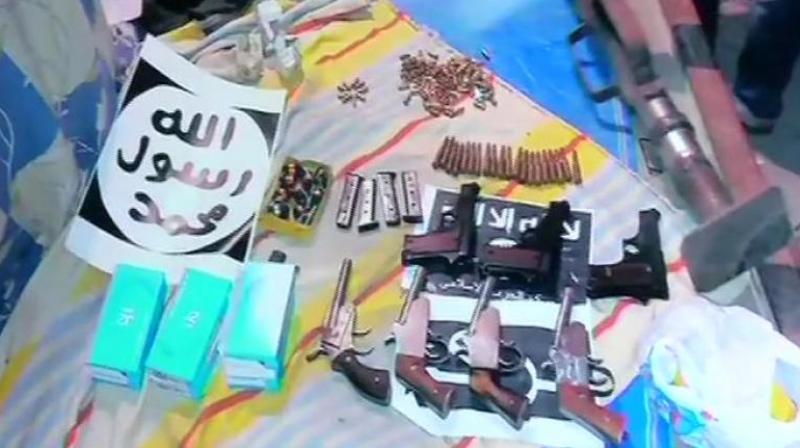 A rocket launcher, several weapons and a cache of ammunition which were recovered by the NIA during its raids in New Delhi on Wednesday.  (PTI)