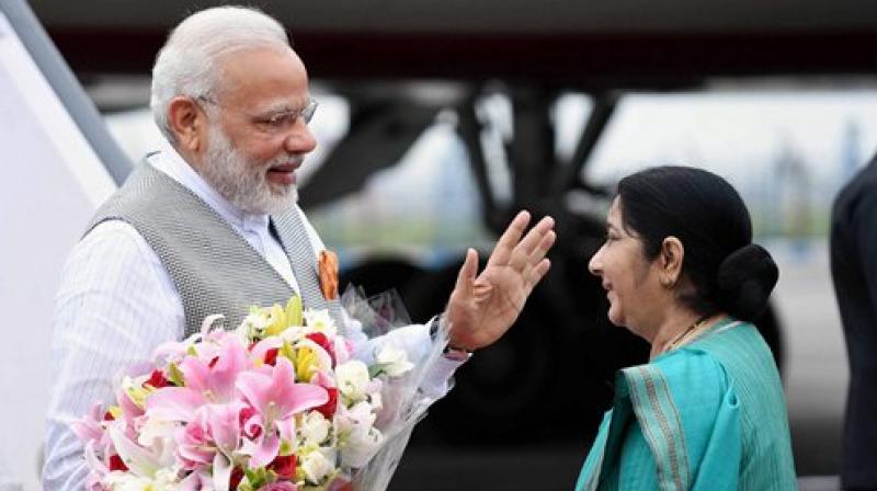 Prime Minister Narendra Modi being received by Union Minister for External Affairs Sushma Swaraj on his arrival after a successful visit to Portugal, USA and Netherlands, at AFS Palam in New Delhi. (Photo: PTI)