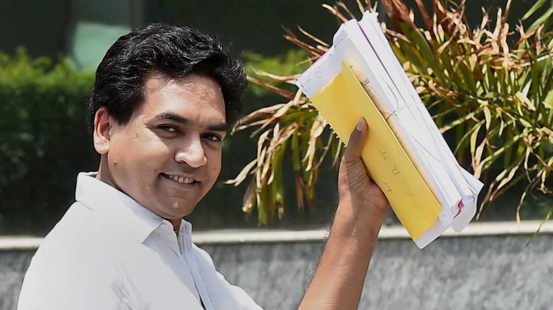 Sacked Delhi Minister Kapil Mishra showing copies of the complaints which he filed against Chief Minister Arvind Kejriwal, at CBI headquarters in New Delhi. (Photo: PTI)