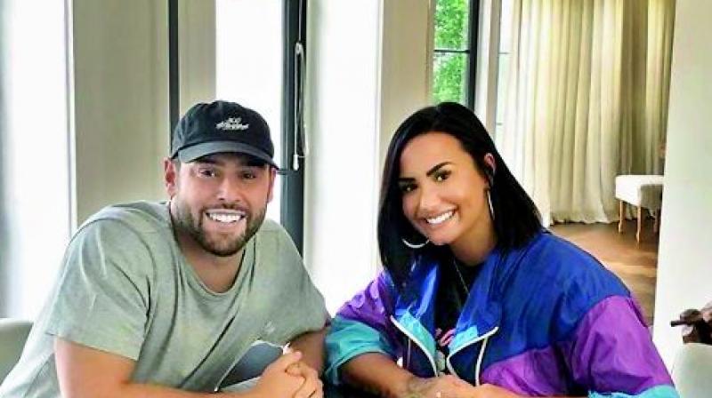 Demi Lovato hires Scooter Braun