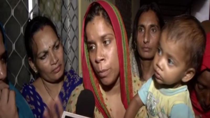They are agitating with the body of Rekhas father-in-law who the family says consumed poison due to police apathy in the case of his sons death. (Photo: ANI)