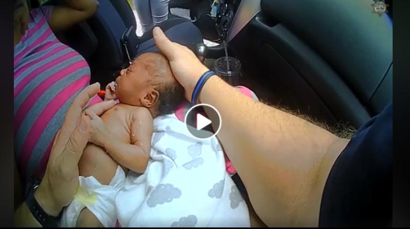 The video released by the police department shows Deputy Kimbro massaging the baby and inserting a finger in her mouth to open her airway. (Photo: Video screengrab | @BerkCoSheriff)