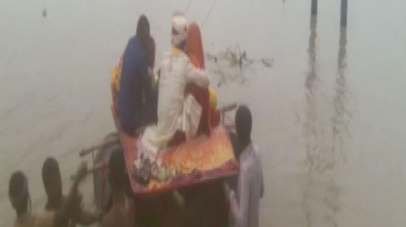 Watch: Newlyweds use makeshift boat to cross flooded road in Bihar