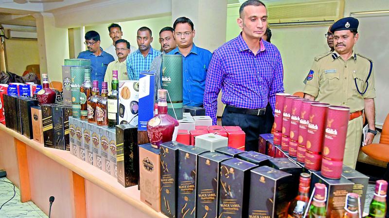 Excise director Akun Sabharwal shows seized foreign liquor bottles to the media. (Photo- DC)