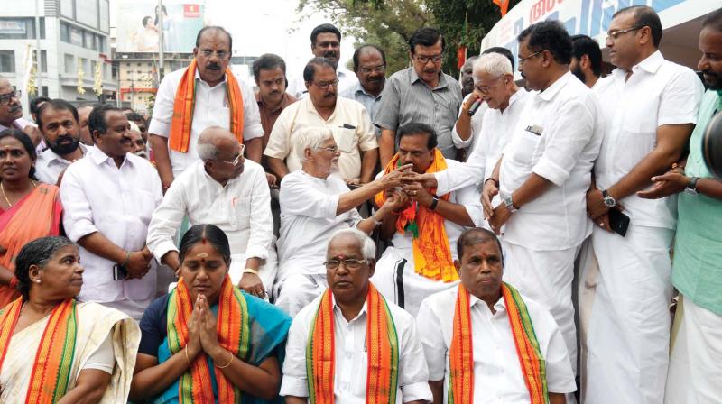 BJP former state president P.K. Krishnadas ends the fast in front of the Secretariat in protest on the Sabarimala issue, by drinking the lime juice offered by Gandhians P. Gopinathan Nair and K. Ayyappan Pillai on Sunday.   (DC)