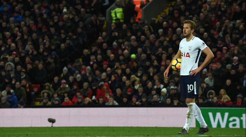 Kane had the last word as his 100th Premier League goal from a controversial stoppage-time penalty handed Spurs a share of the spoils at Anfield. (Photo: AFP)