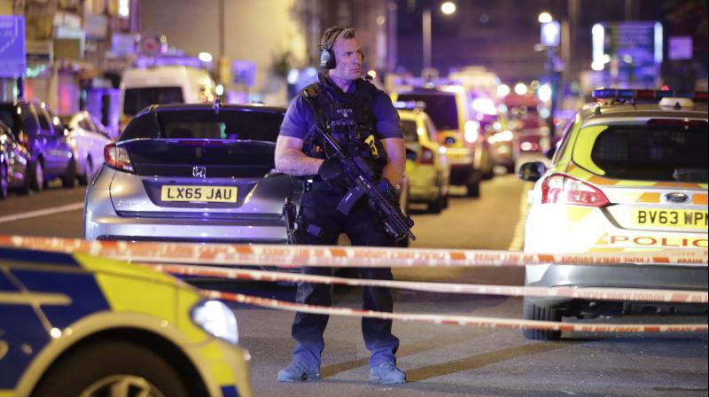 An armed police officer mans a cordon on the Seven Sisters Road at Finsbury Park where a vehicle struck pedestrians in London Monday. (Photo: AP)