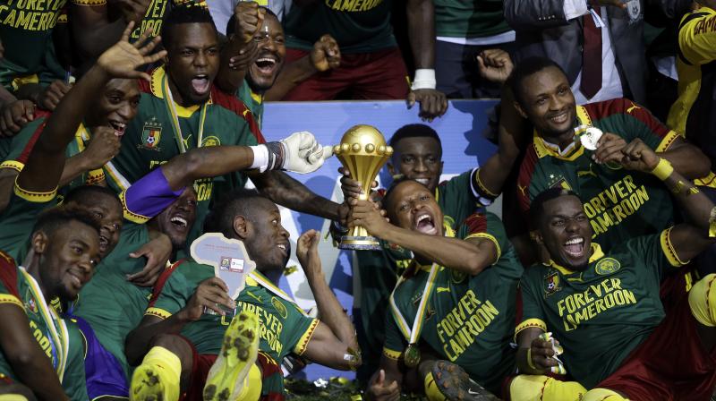 Cameroon players celebrate with the trophy after winning the African Cup of Nations final. (Photo: AP)