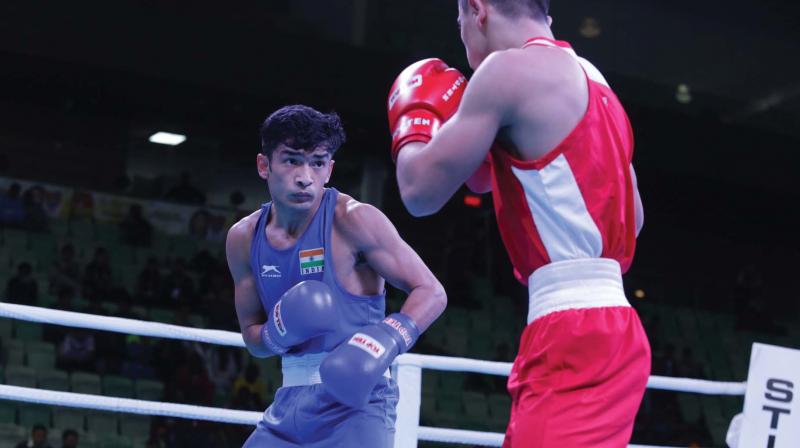 Shiva Thapa (left) in action against Rakhmatulloev Sherbek of Uzbekistan in their India Open semi-final bout in New Delhi on Tuesday.