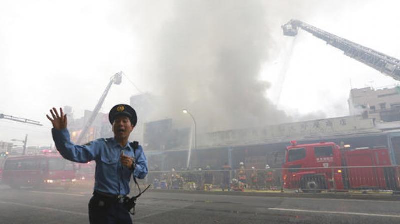 The fire broke out at a three-story building around 1:20 pm IST (0750 GMT), burning around 200 square metres (2,150 square feet) of the area, public broadcaster NHK said. (Photo: AP)