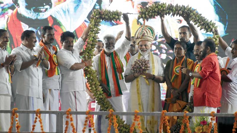 Prime Minister Narendra Modi being garlanded by BJP leaders at Central Stadium in Thiruvananthapuram where he address an election rally on Thursday. NDA candidates in Thiruvananthapuram and Attingal, Kummanam Rajasekharan and Sobha Surendran, BJP state president P. S. Sreedharan Pillai, BJP TVM president S. Suresh, and BJP state general secretary M.T. Ramesh are seen.A.V. MUZAFAR
