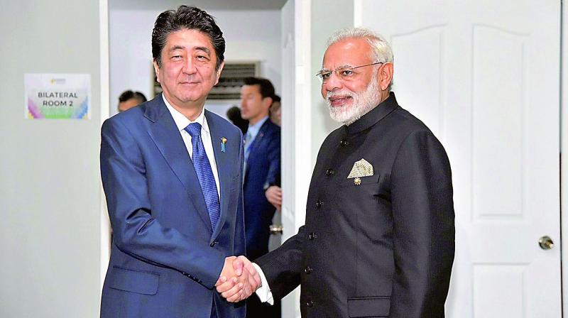 Prime Minister Narendra Modi with his Japanese counterpart Shinzo Abe, in Manila, on Tuesday. (Photo: PTI)
