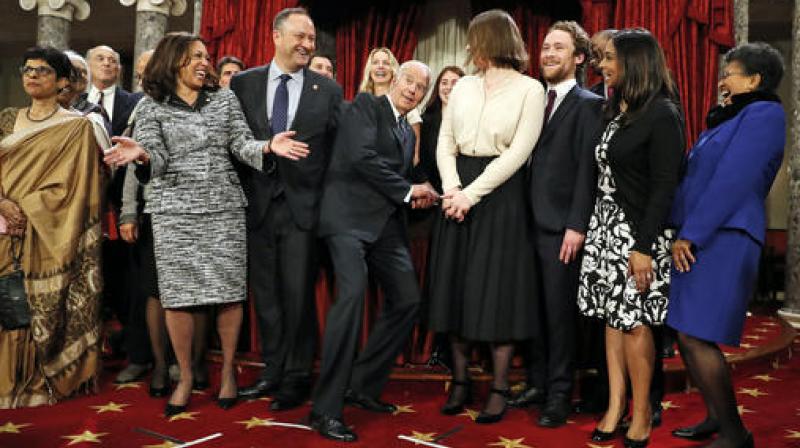 VP Joe Biden, center, ducks down so all of the family of Sen. Kamala Harris, D-Calif., second from right, can be seen for a group photo during a mock swearing in ceremony in the Old Senate Chamber on Capitol Hill in Washington. (Photo: AP)