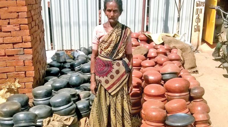 A woman selling clay pots for Pongal festival at Thanjavur on Monday. (Photo: DC)