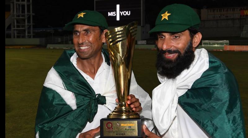 Younis Khan(Left) and captain Misbah ul Haq pose with the trophy after winning the test series against West Indies. (Photo: AFP)