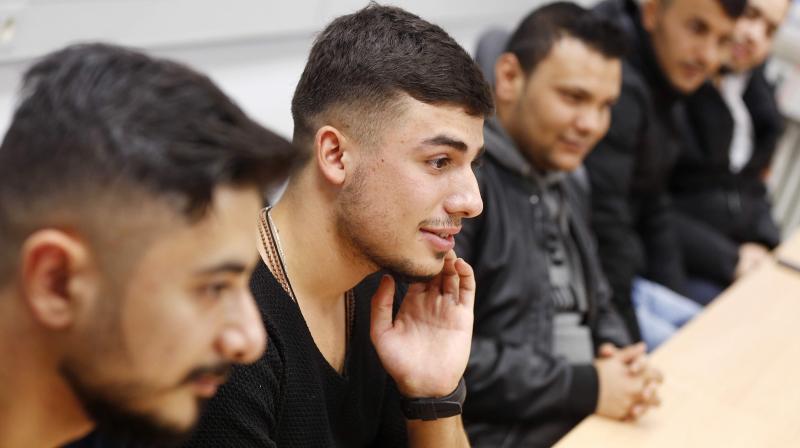 Essam Kadib al Ban, second from left, takes part in a flirt workshop for refugees in Dortmund, Germany. (Photo: AP)